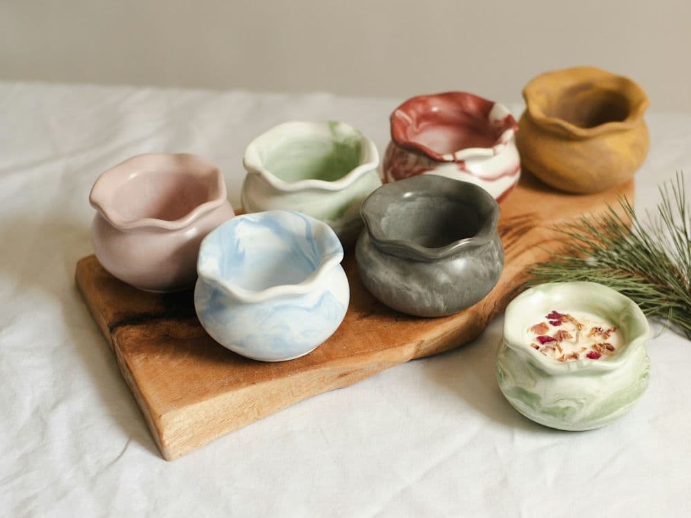 Small glazed bowls in soft colours on a wooden board
