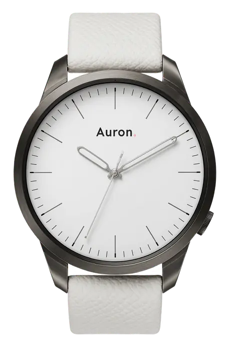 A gunmetal watch with a white dial on a white strap