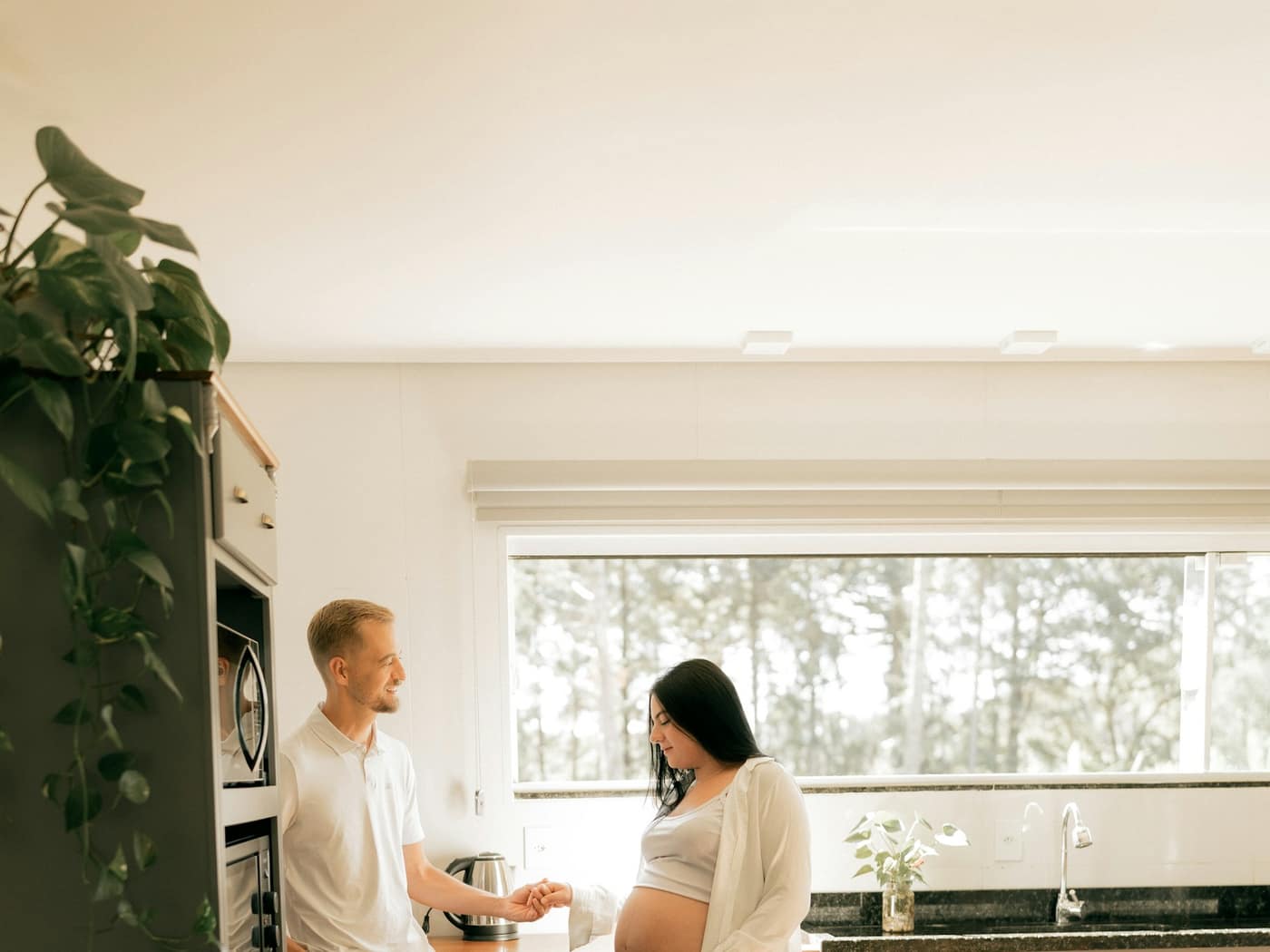 A couple talking in the doorway of their finished kitchen
