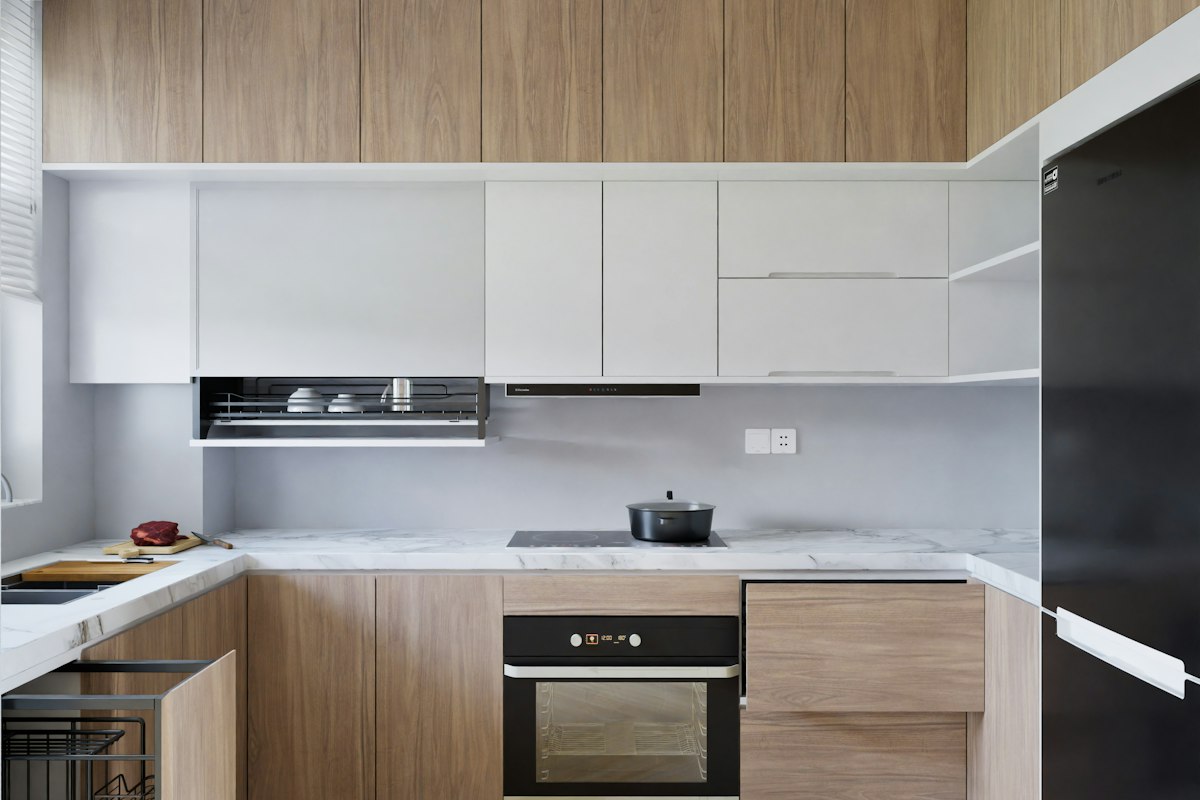 a kitchen with a stove top oven next to a refrigerator