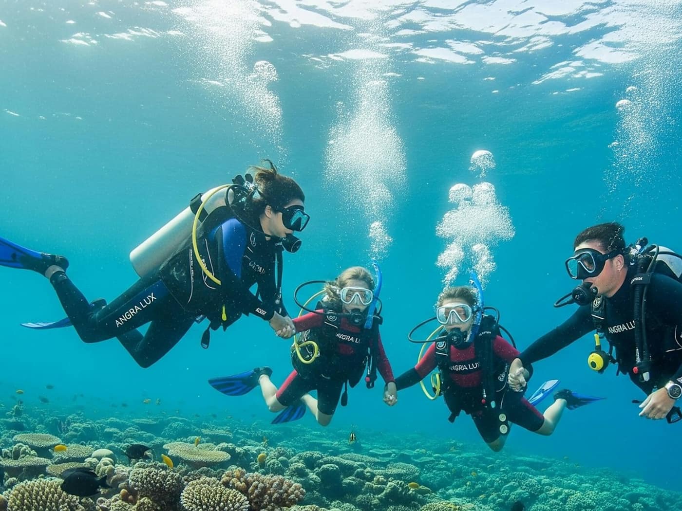 Three divers exploring the reef together on a try dive