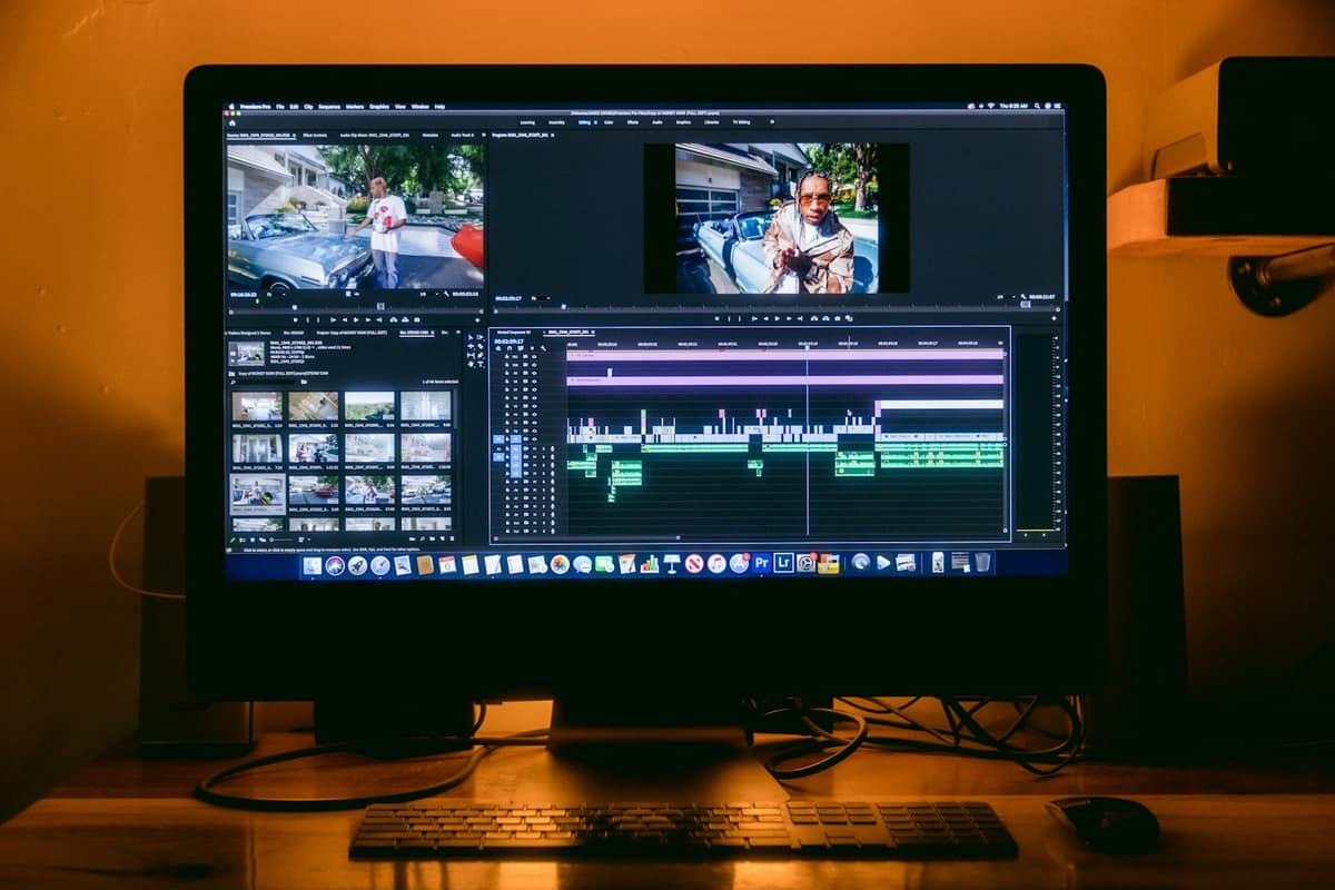 An editing suite with a large monitor showing a timeline, glowing in warm light